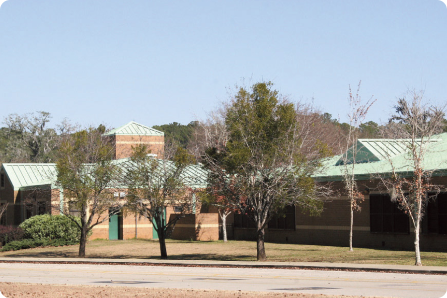 school building with trees in front